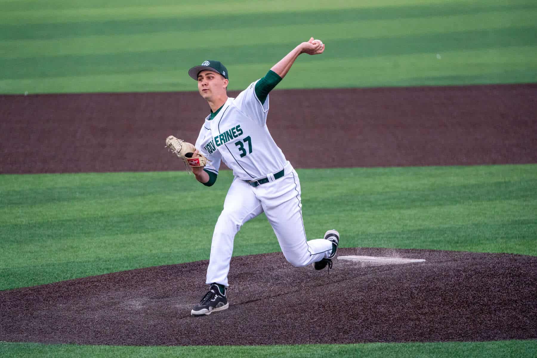 UVU baseball player pitching on the field, wearing jersey number 37, during a game at UVU Wolverines sports event.