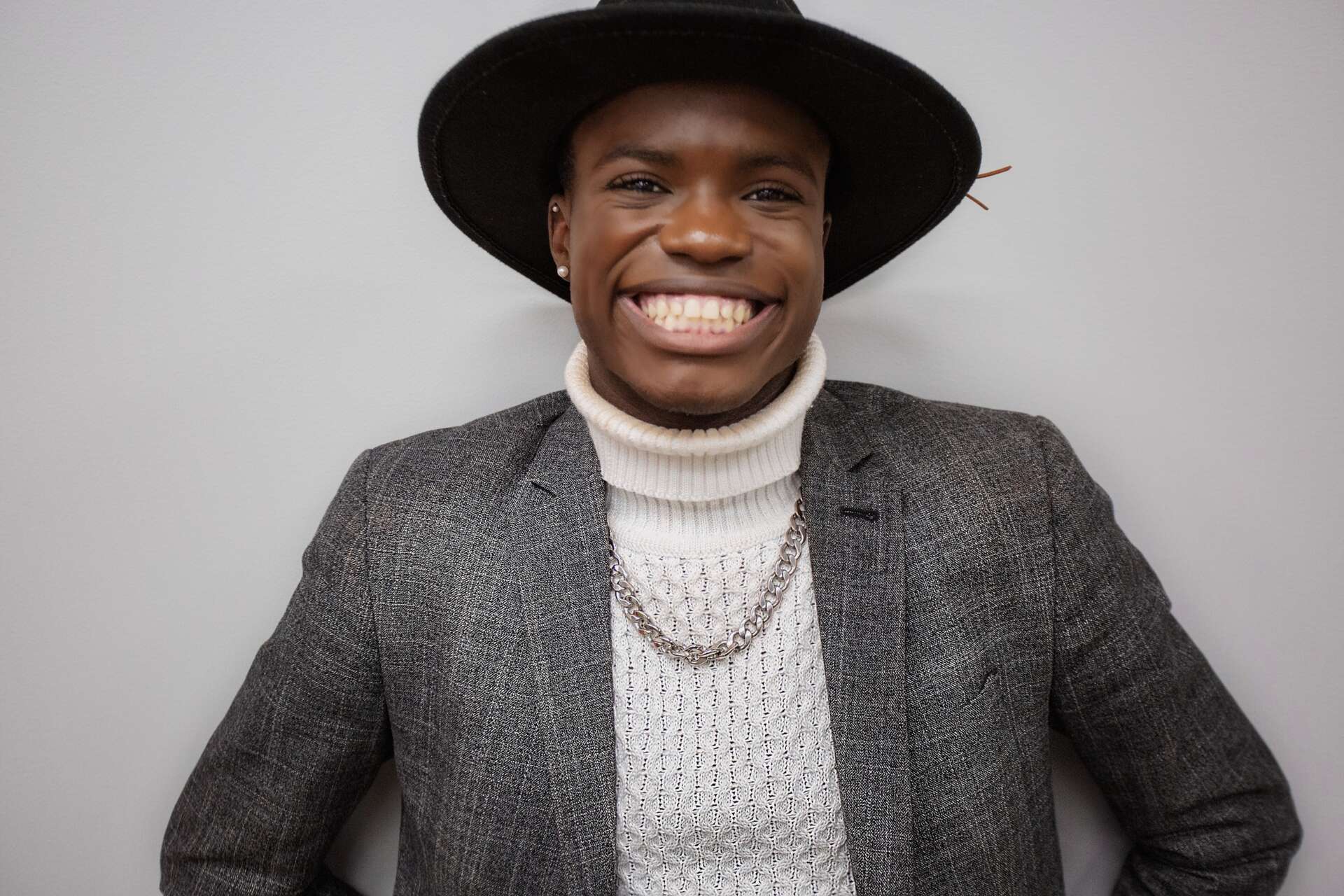 Young African American college student smiling in academic attire at UVU Review, showcasing diversity and student achievements on campus.